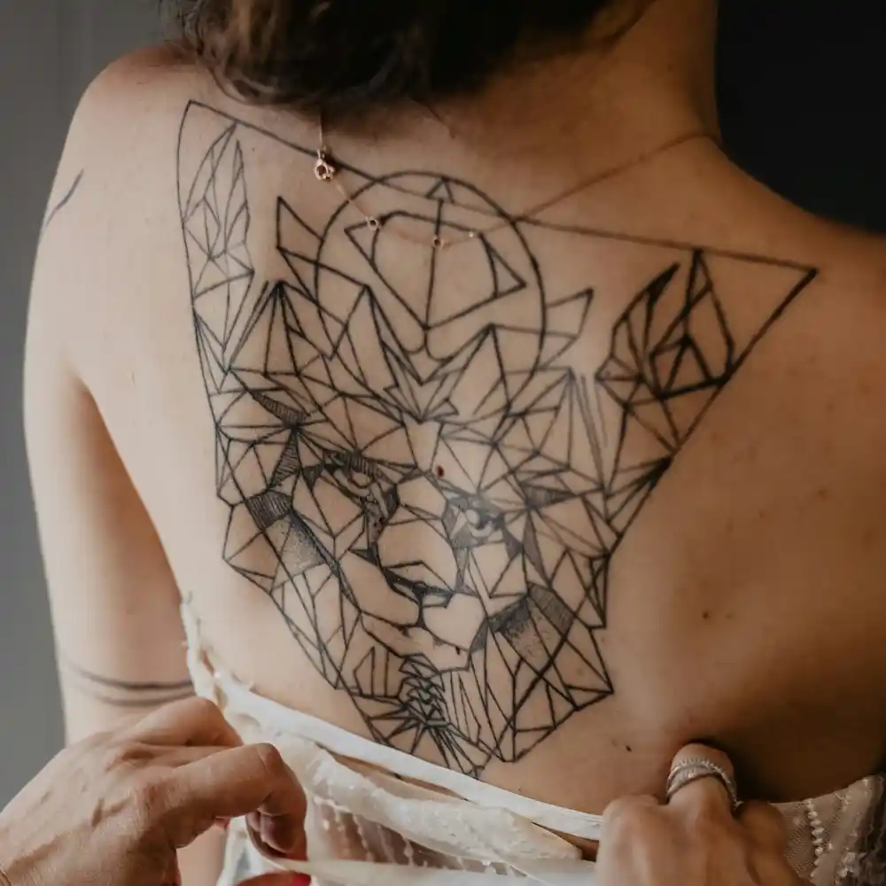 A large geometric lion tattoo