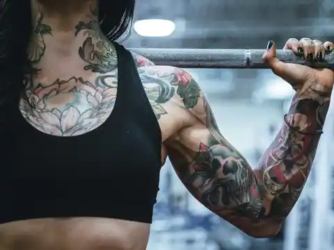 A woman with tattoos in the gym