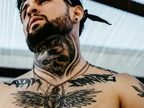 A neck and chest dark tattoo