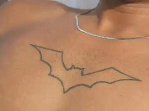 A tattooed outline of a bat