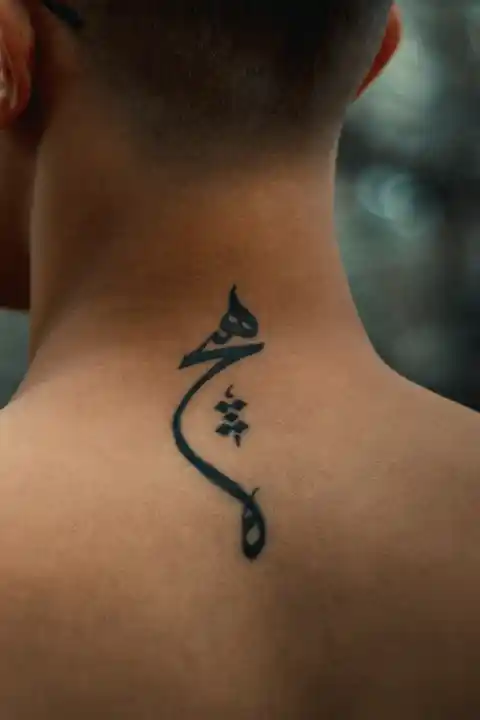 A tattoo of a character on the back of the neck