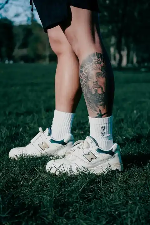 A tattoo of Jesus on the lower leg