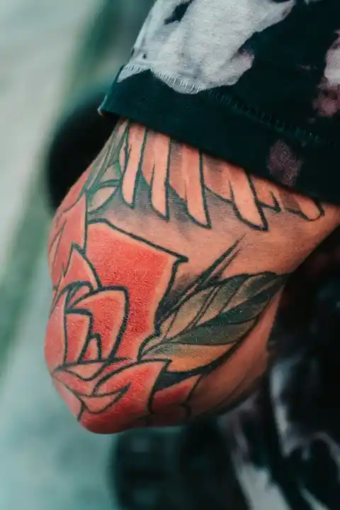 A rose tattoo on the elbow