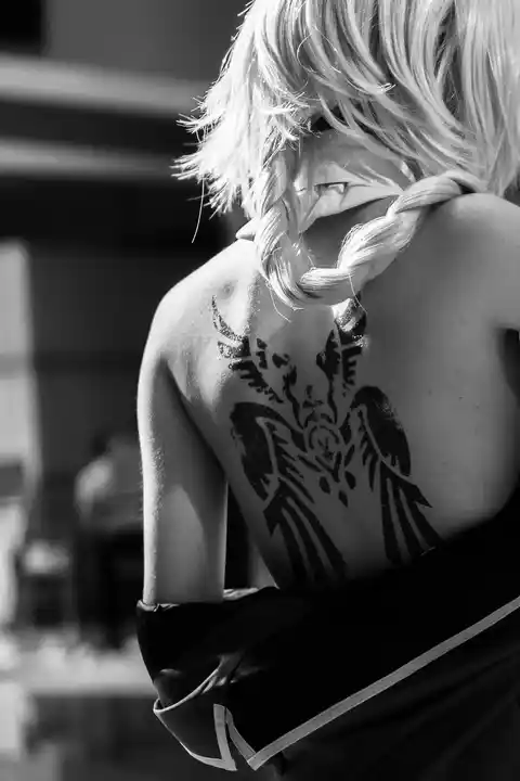 A tattoo of wings on the back of a woman