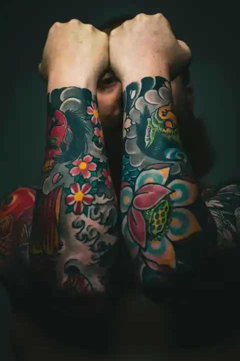 A colourful floral forearm tattoo