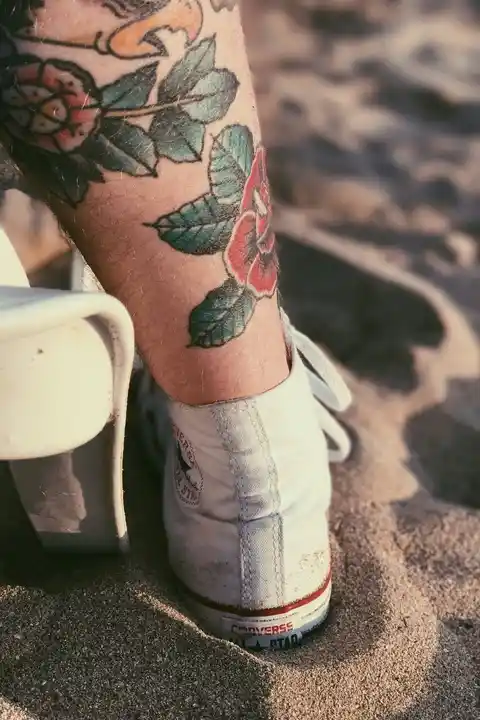 A tattoo of flowers on the lower leg