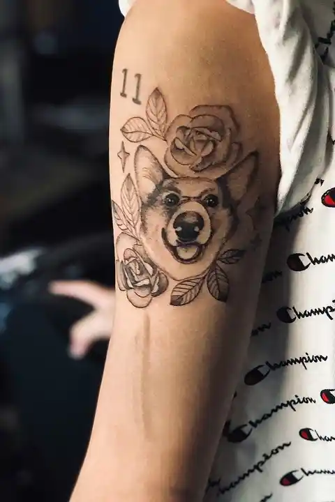 A tattoo of a dog on the upper arm