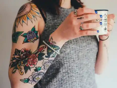 A colourful sleeve tattoo of flowers