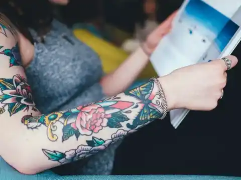 A colourful sleeve tattoo of flowers