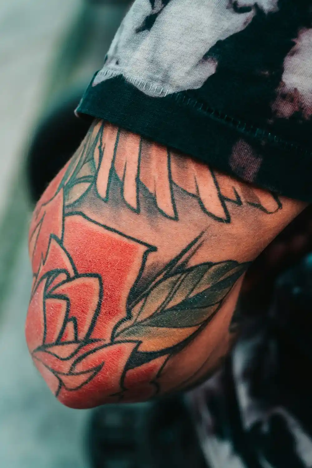 A tattoo of a rose on an elbow