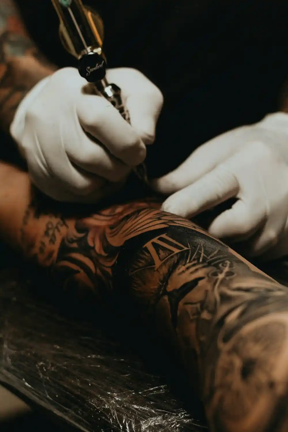 A man's arm is being tattooed