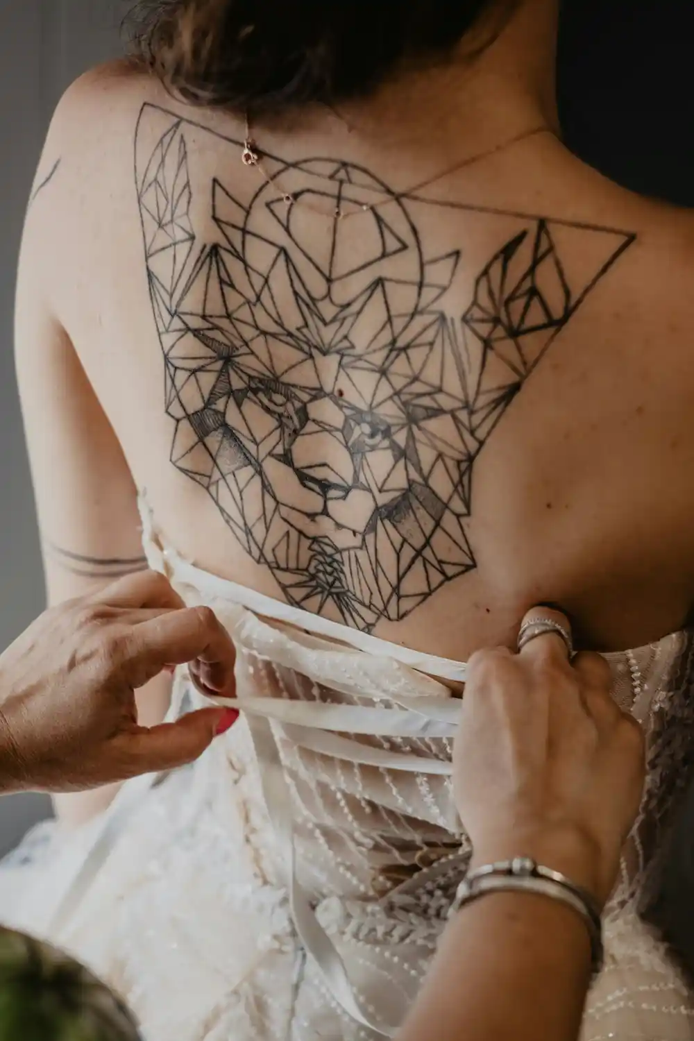 A large tattoo of a lion on a woman's back