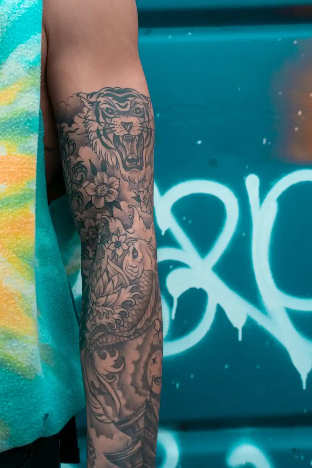 A full sleeve big tattoo with a big cat