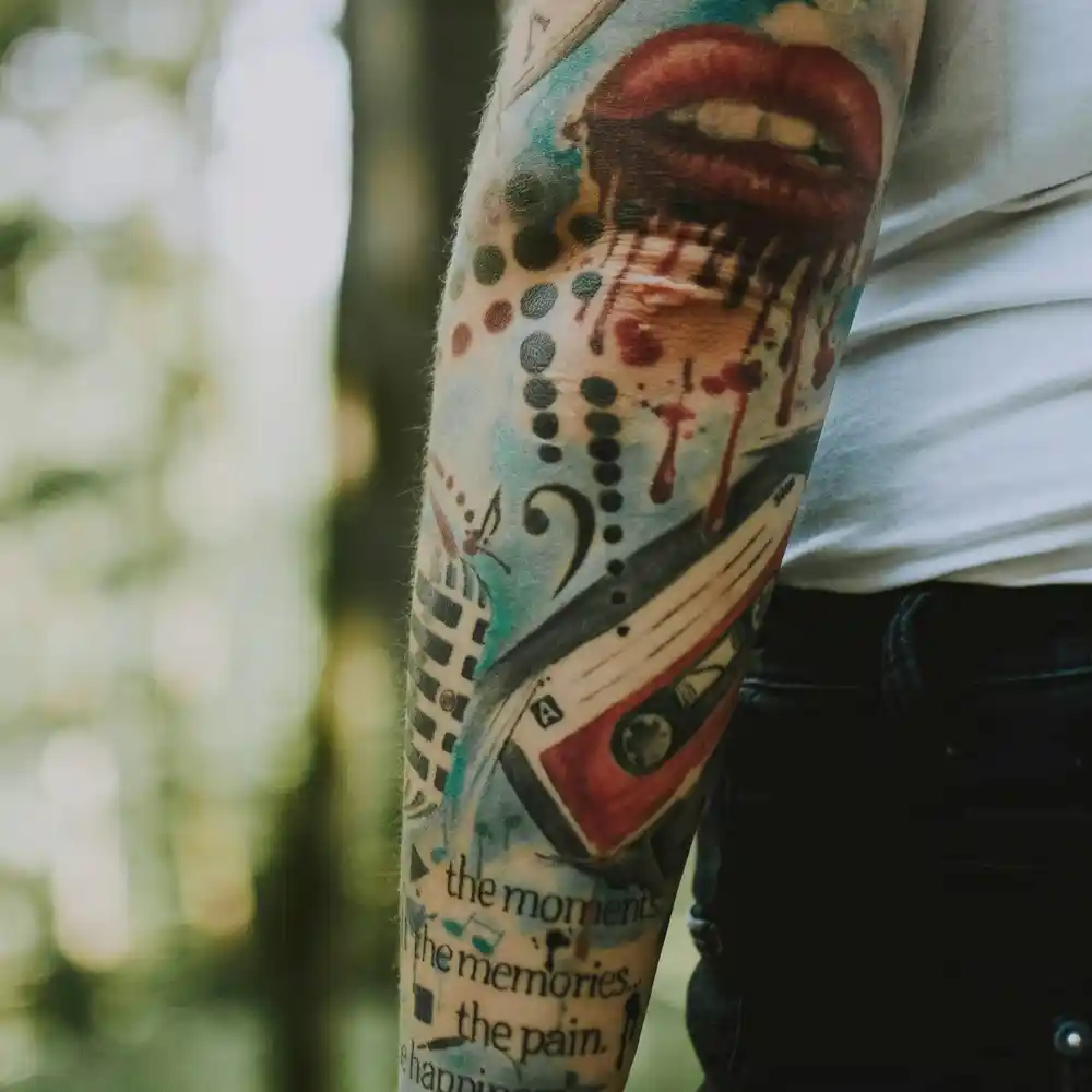 A sleeve of music-themed colourful tattoos